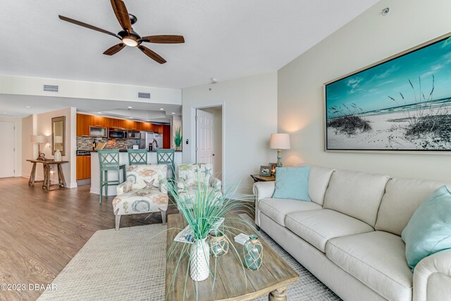 231 Riverside Dr Unit 1806, Holly Hill, FL 32117 - living area featuring wood finished floors and a ceiling fan