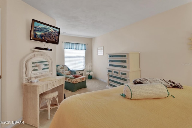 bedroom with baseboards and light colored carpet