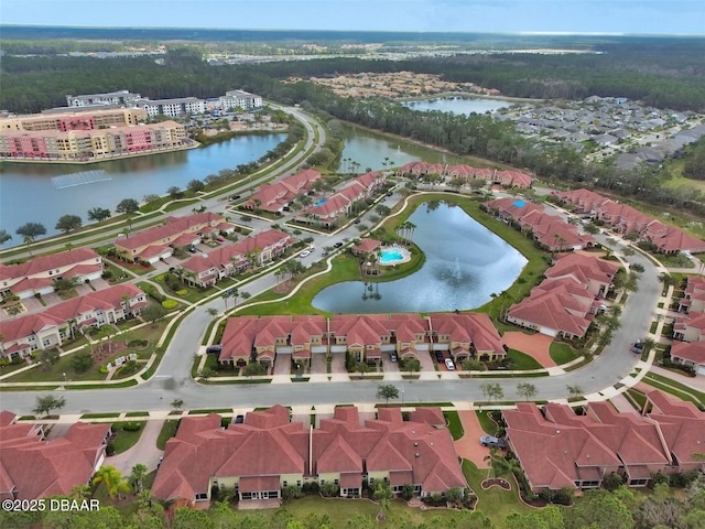 drone / aerial view with a water view and a residential view