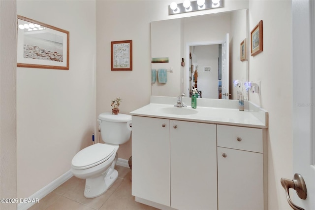 half bath featuring baseboards, vanity, toilet, and tile patterned floors