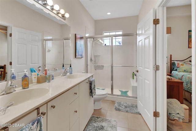 bathroom featuring a stall shower, tile patterned flooring, a sink, and ensuite bathroom