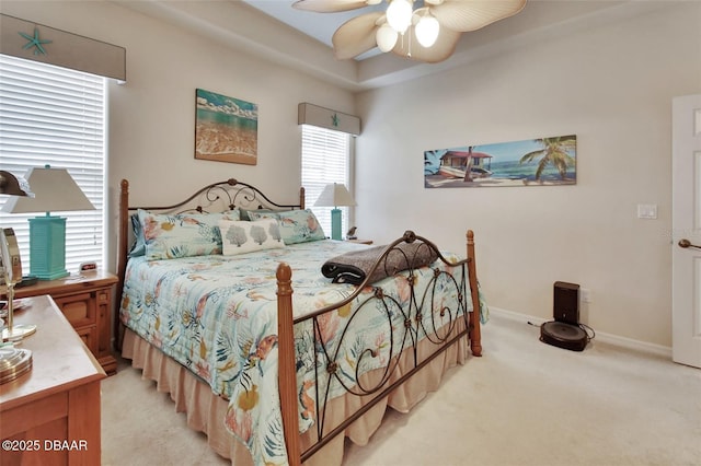 bedroom with baseboards, a ceiling fan, and light colored carpet