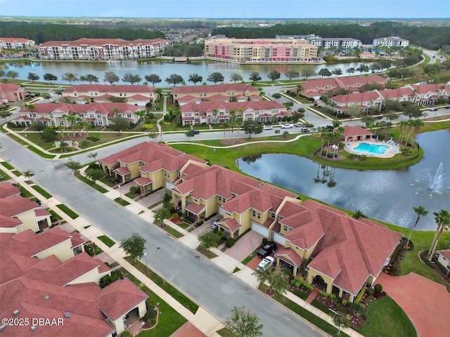 drone / aerial view featuring a water view and a residential view