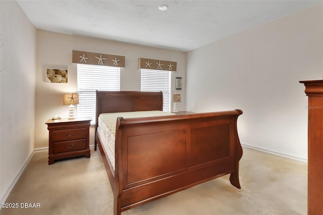 bedroom with baseboards and light colored carpet