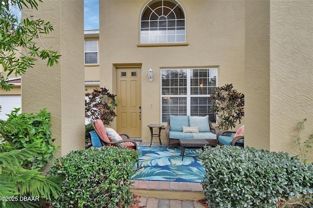 property entrance featuring a patio and stucco siding