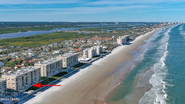 drone / aerial view featuring a beach view and a water view