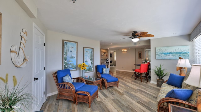 sitting room featuring hardwood / wood-style flooring and ceiling fan