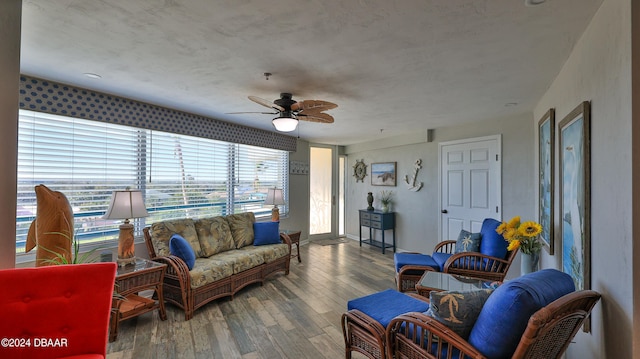 living room with hardwood / wood-style flooring and ceiling fan