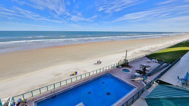 view of pool featuring a beach view and a water view