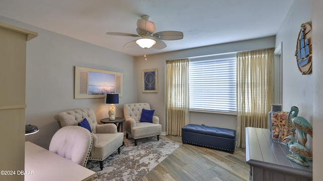 sitting room featuring light hardwood / wood-style flooring and ceiling fan