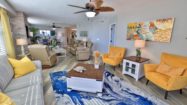 living room featuring light wood-type flooring and ceiling fan