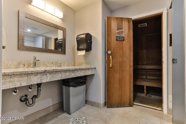 bathroom with tile patterned flooring, baseboards, and a sauna / steam room