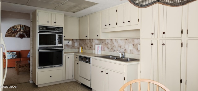 kitchen featuring a sink, white dishwasher, open shelves, decorative backsplash, and light countertops