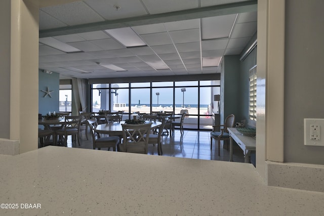 dining area featuring a paneled ceiling