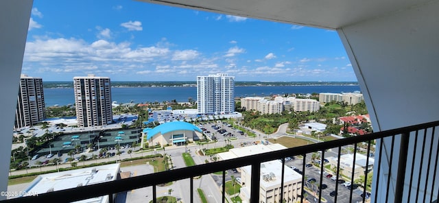 balcony featuring a water view and a view of city