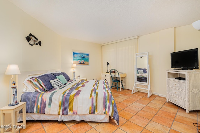 bedroom featuring light tile patterned flooring and a textured ceiling