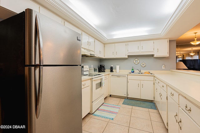 kitchen featuring a tray ceiling, light tile patterned flooring, a sink, white appliances, and under cabinet range hood