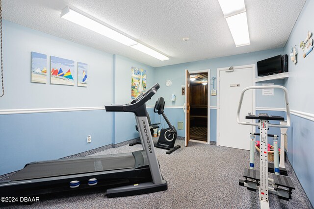 exercise room featuring a textured ceiling