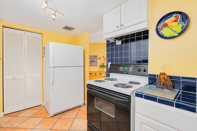 kitchen with tile countertops, white appliances, backsplash, white cabinets, and light tile patterned flooring