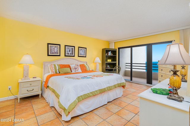 bedroom featuring baseboards and access to exterior