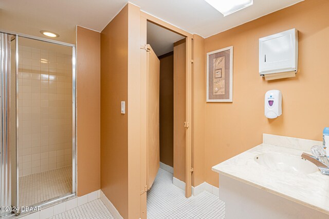 bathroom featuring baseboards, a stall shower, recessed lighting, and tile patterned floors