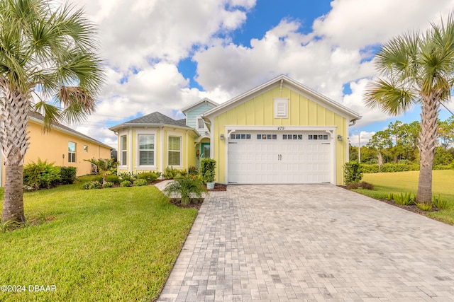 view of front facade with a front yard and a garage