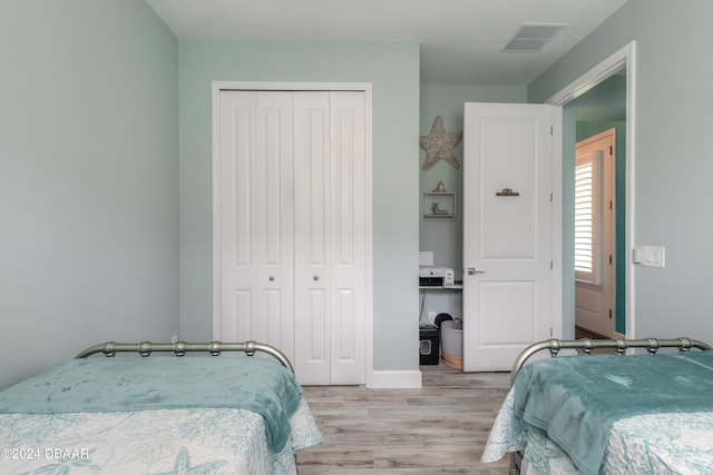 bedroom featuring a closet and light hardwood / wood-style floors