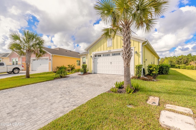 view of front of property with a garage and a front lawn