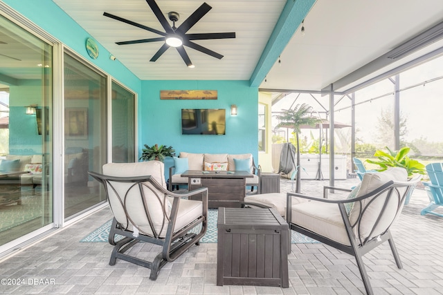 sunroom featuring ceiling fan