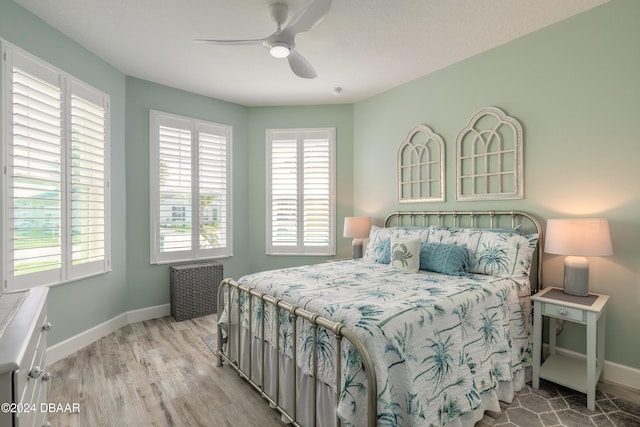 bedroom with ceiling fan and light hardwood / wood-style flooring