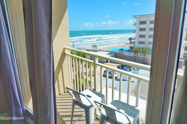 balcony with a view of the beach and a water view