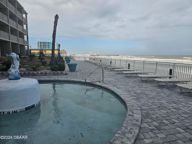 view of pool with a water view