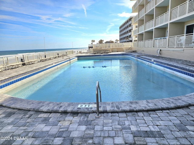 view of pool with a water view