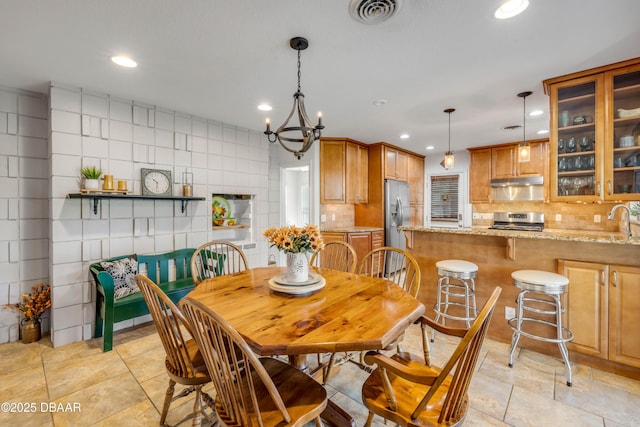 200 W Washington Ave, Deland, FL 32720 - dining area featuring recessed lighting, light tile patterned floors, and a chandelier