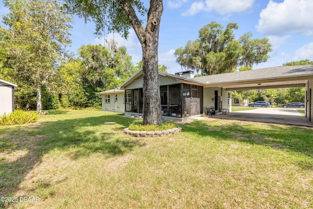 200 W Washington Ave, Deland, FL 32720 - view of grassy yard featuring an attached carport and a sunroom