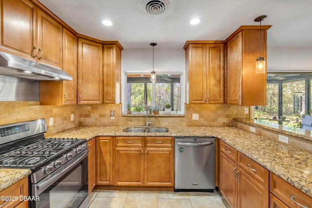 200 W Washington Ave, Deland, FL 32720 - kitchen featuring appliances with stainless steel finishes, under cabinet range hood, a sink, ceiling fan, and brown cabinets