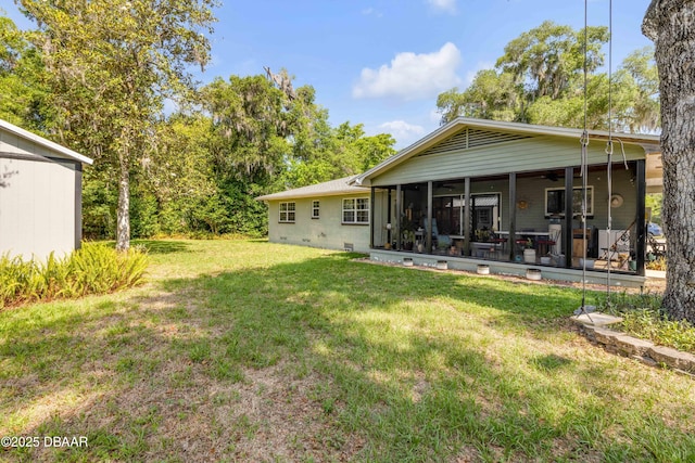 200 W Washington Ave, Deland, FL 32720 - rear view of house with a lawn and a sunroom