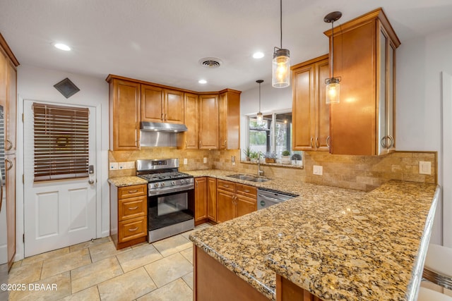 200 W Washington Ave, Deland, FL 32720 - kitchen featuring stainless steel appliances, a sink, a peninsula, under cabinet range hood, and light stone countertops