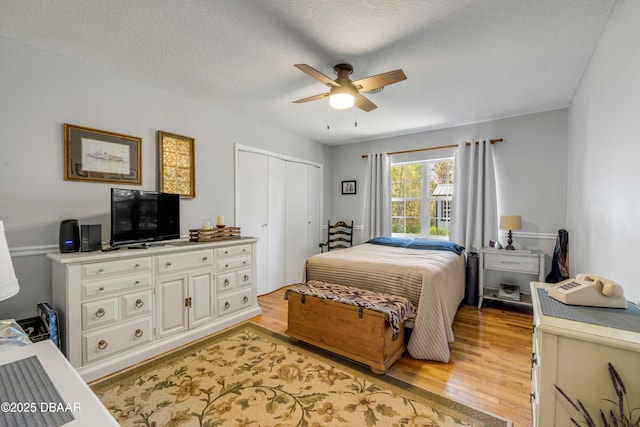 200 W Washington Ave, Deland, FL 32720 - bedroom with light wood-type flooring, a closet, a ceiling fan, and a textured ceiling