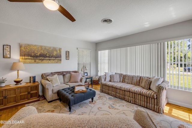 200 W Washington Ave, Deland, FL 32720 - living area featuring wood finished floors, baseboards, ceiling fan, and a textured ceiling