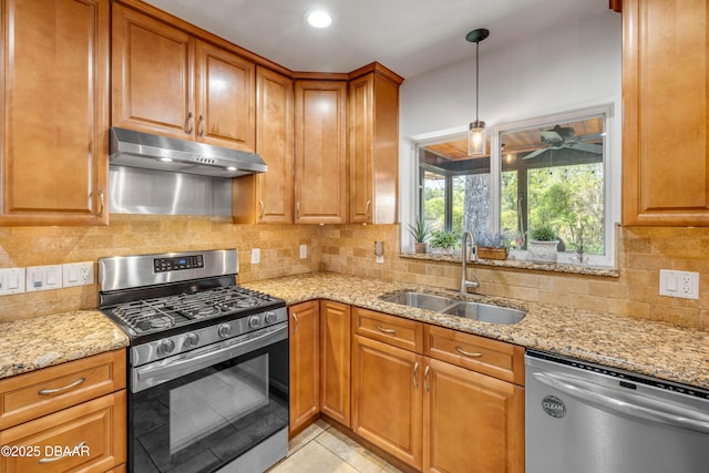 200 W Washington Ave, Deland, FL 32720 - kitchen featuring stainless steel appliances, a sink, under cabinet range hood, and light stone countertops