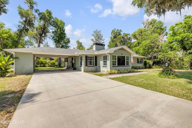 200 W Washington Ave, Deland, FL 32720 - ranch-style house featuring concrete driveway, a front yard, a chimney, and a carport