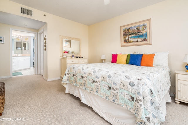 carpeted bedroom with ensuite bath