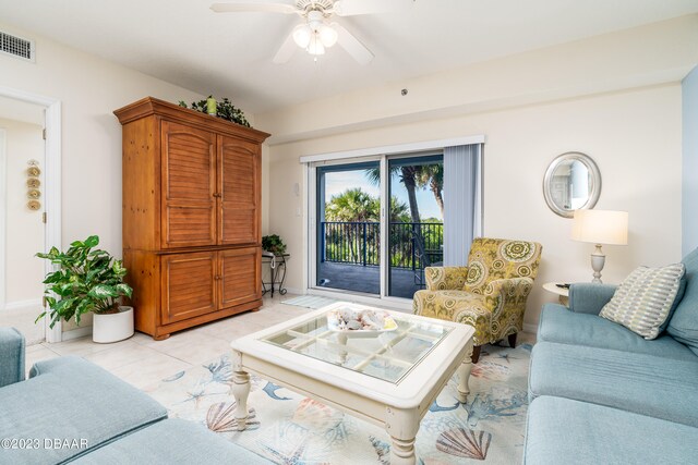 tiled living room featuring ceiling fan