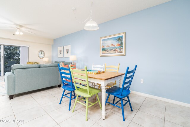 tiled dining room featuring ceiling fan