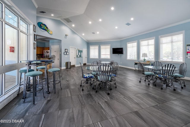 dining area featuring vaulted ceiling and crown molding