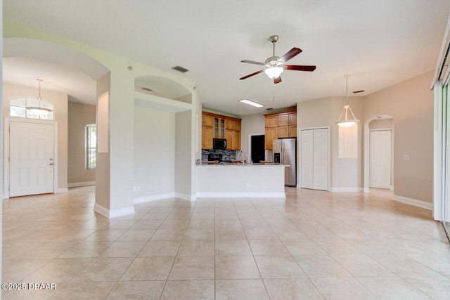 1832 Afshin Ct, Port Orange, FL 32128 - unfurnished living room with arched walkways, ceiling fan, and light tile patterned flooring