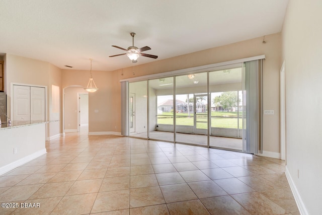 1832 Afshin Ct, Port Orange, FL 32128 - spare room with a ceiling fan, arched walkways, and light tile patterned floors