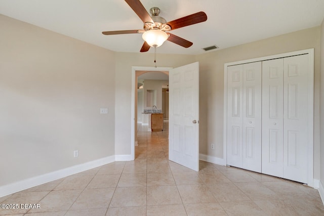 1832 Afshin Ct, Port Orange, FL 32128 - unfurnished bedroom featuring arched walkways, a closet, light tile patterned floors, and ceiling fan