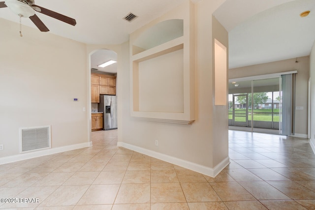 1832 Afshin Ct, Port Orange, FL 32128 - unfurnished room featuring light tile patterned flooring, a ceiling fan, arched walkways, and a smoke detector